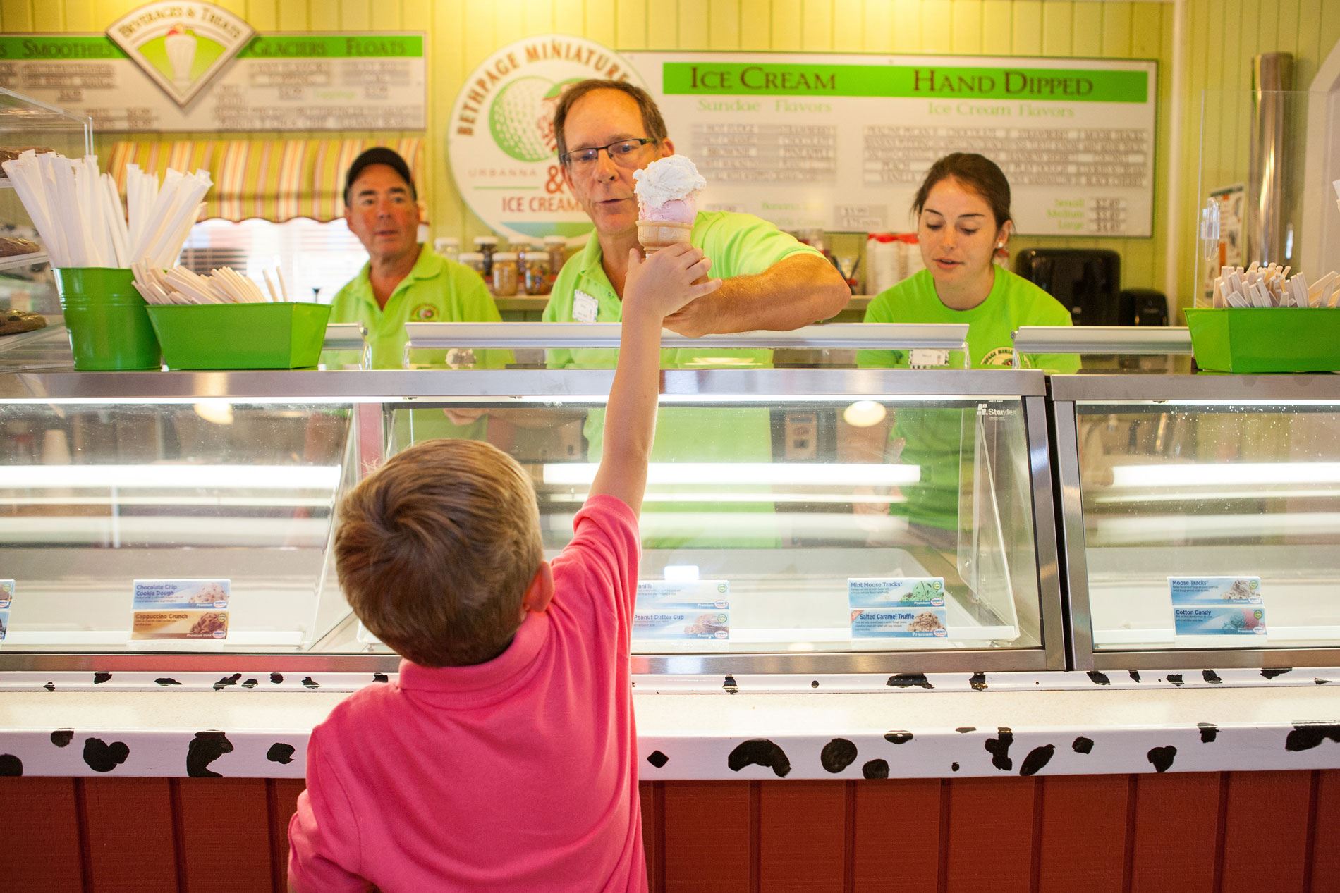 Child receiving an ice cream cone at Bethpage Ice Creamery
