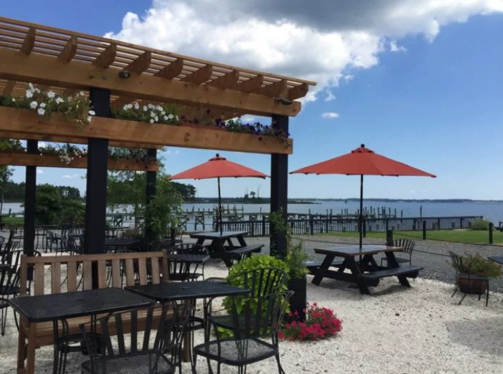 Outdoor seating under a trellis on the coast at Merroir