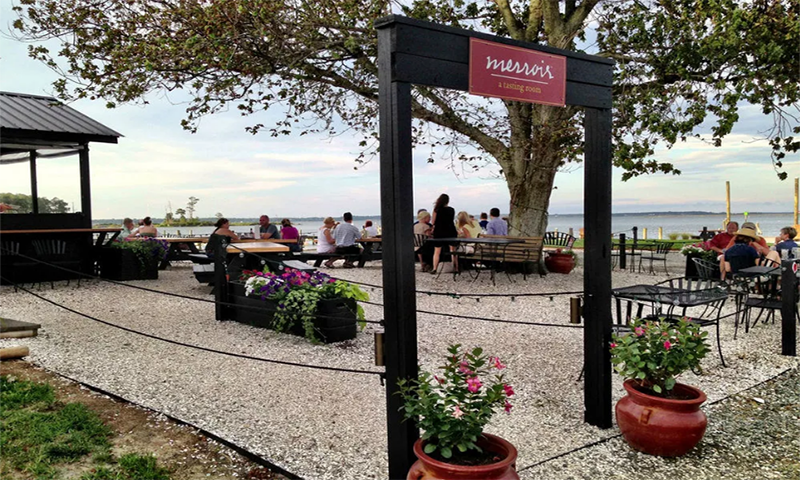 Outdoor seating with a coastal view at Merroir