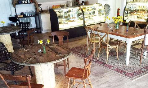 Inside seating and food display cases at The Table to Go
