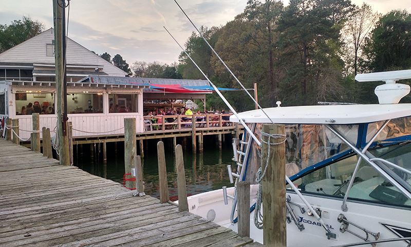 Dockside seating with customers at the Urbanna Seafood and Raw Bar