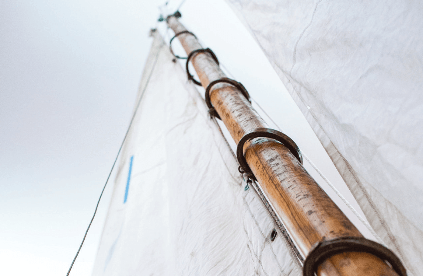 Close up view of a mast with a rigged sail